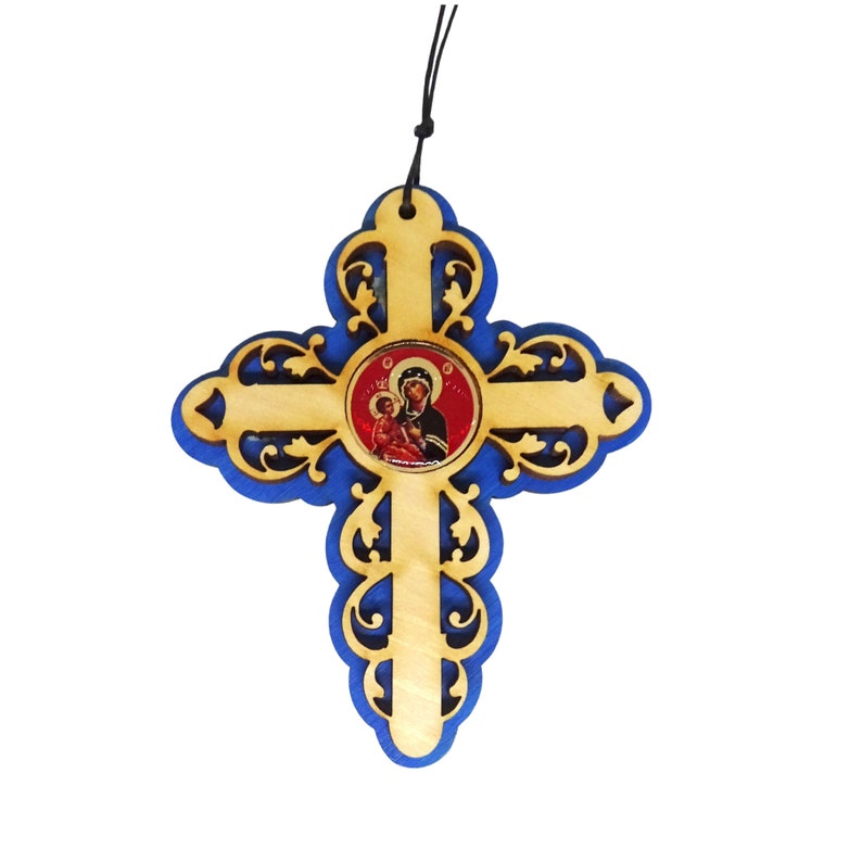 May include: A wooden cross with a blue border and a round icon of the Virgin Mary and baby Jesus in the center. The cross has a decorative, ornate design.