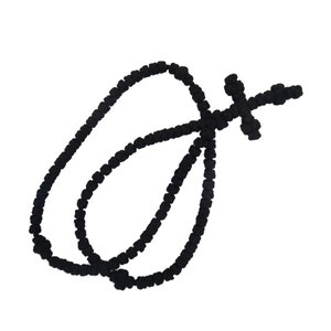May include: A black knotted prayer rope with a cross at the end. The rope is made of small, round beads.