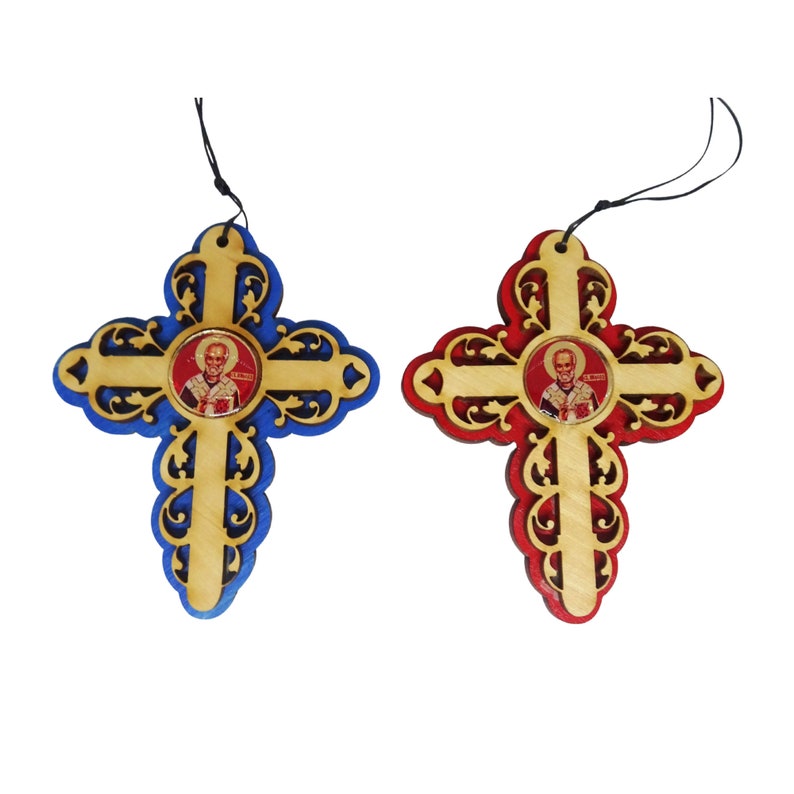 May include: Two wooden crosses with intricate designs, one blue and one red, each featuring a small round image of a saint in the center.