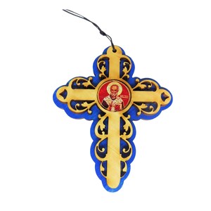 May include: A wooden cross with a blue background and intricate carvings. A small image of a saint is in the center of the cross.