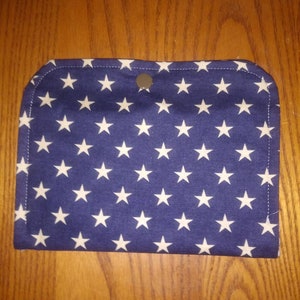 May include: A small blue fabric pouch with a white star pattern and a silver button closure.
