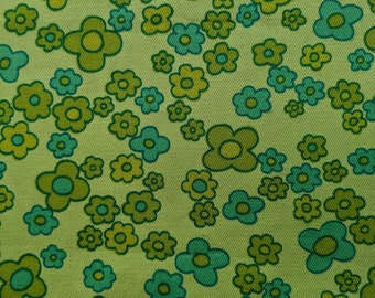 May include: Close-up of a fabric with a repeating floral pattern. The flowers are in shades of green and teal, set against a light green background. The design has a retro, vintage aesthetic.