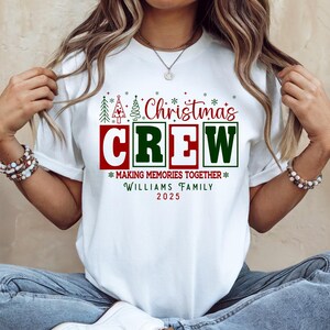 May include: White t-shirt with a festive Christmas design. The graphic includes the words "Christmas CREW" in red and green, plus the phrases "MAKING MEMORIES TOGETHER" and "WILLIAMS FAMILY 2025".