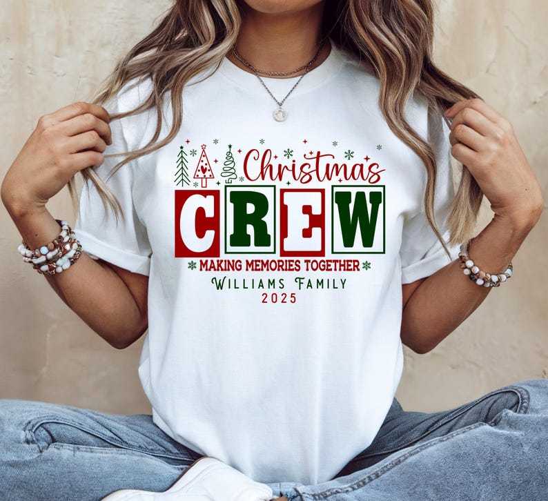 May include: White t-shirt with a festive Christmas design. The graphic includes the words "Christmas CREW" in red and green, plus the phrases "MAKING MEMORIES TOGETHER" and "WILLIAMS FAMILY 2025".