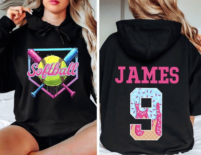 May include: Black hooded sweatshirt with a softball graphic on the front and the name "JAMES" and the number "9" with a pink and blue ice cream design on the back.