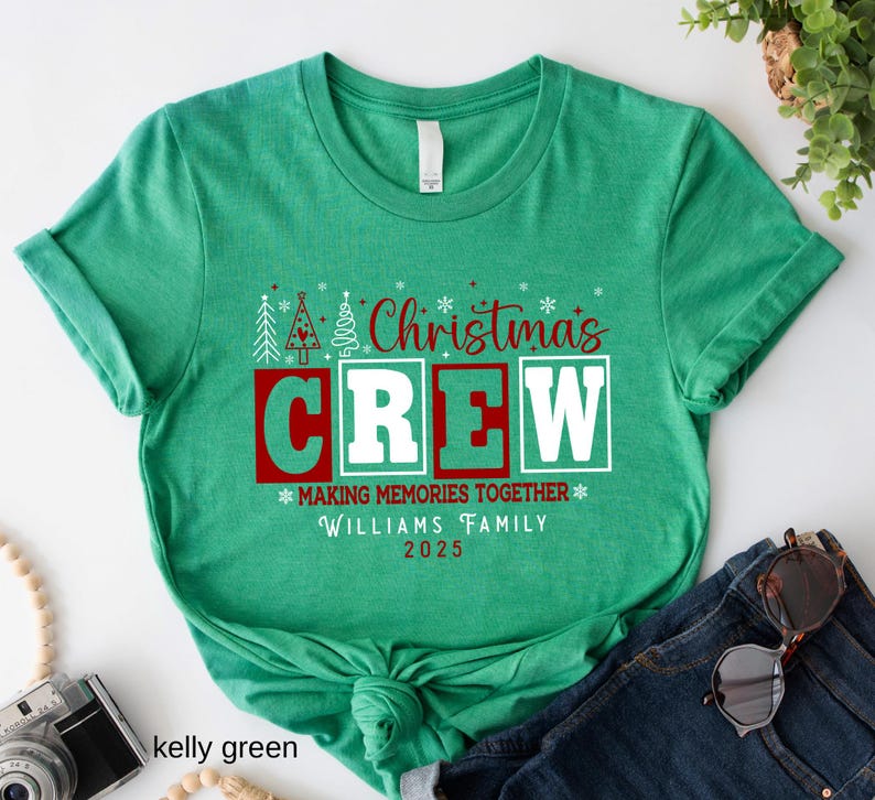 May include: Kelly green t-shirt featuring the text "Christmas CREW" in red and white. The shirt also includes the text "MAKING MEMORIES TOGETHER" and "WILLIAMS FAMILY 2025".