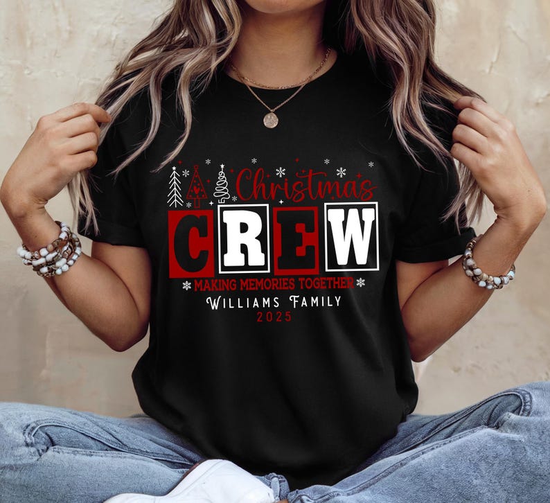 May include: Black t-shirt with the words "Christmas CREW" in white and red block letters. The shirt also includes the text "MAKING MEMORIES TOGETHER" and "WILLIAMS FAMILY 2023" in white. Festive Christmas tree graphics are above the word "Christmas".
