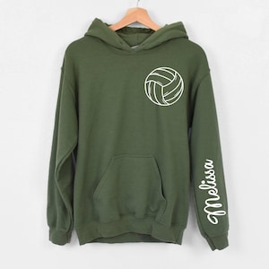 May include: A green hooded sweatshirt with a white volleyball graphic on the front and the name "Melissa" on the sleeve.