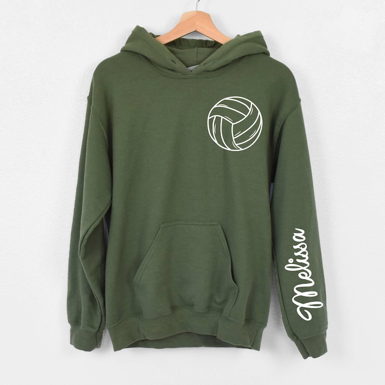May include: A green hooded sweatshirt with a white volleyball graphic on the front and the name "Melissa" on the sleeve.