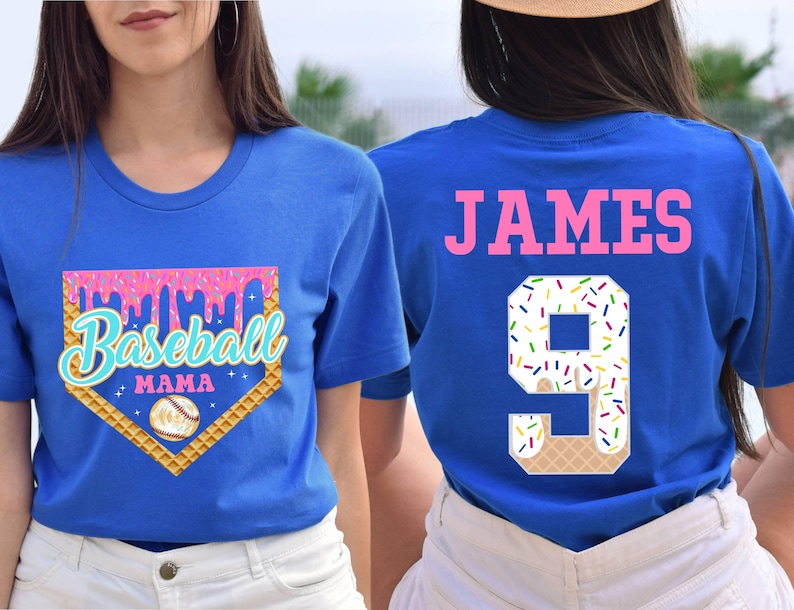 May include: Two blue t-shirts, one with a baseball-themed design that says "Baseball Mama" and the other with the name "JAMES" and the number "9" in a white and pink ice cream cone design.