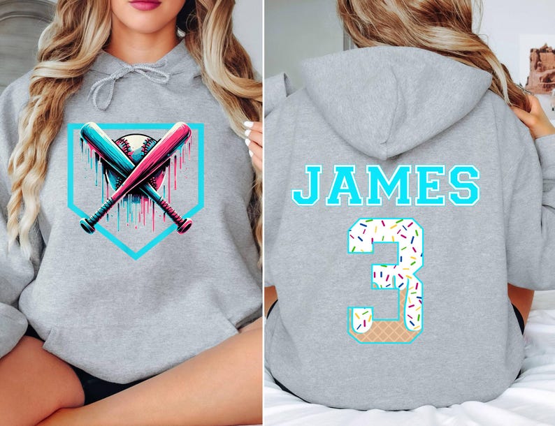 May include: Gray hoodie featuring a baseball design with crossed bats and a baseball, accented with teal and pink. The back displays the name "JAMES" and the number "3" with a waffle cone design.
