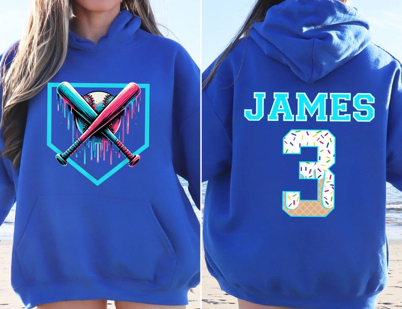 May include: Royal blue hoodie featuring a baseball design on the front with crossed bats and a baseball. The back displays the name "JAMES" and the number "3" designed as an ice cream cone with sprinkles.