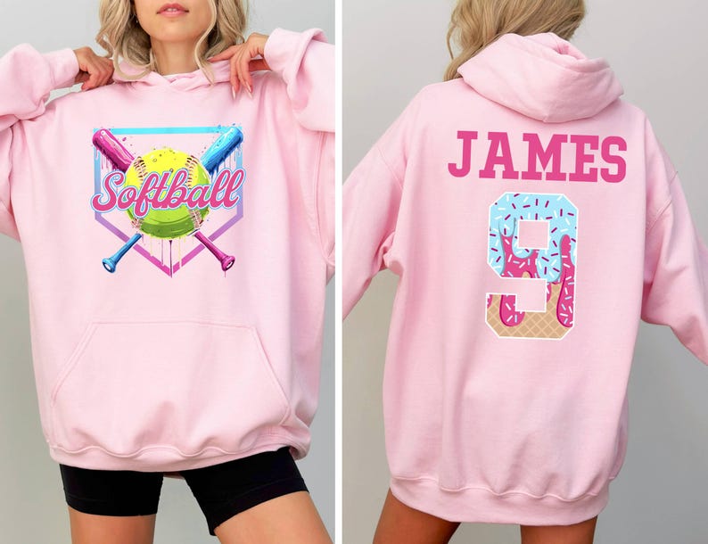 May include: Pink hooded sweatshirt with a softball graphic on the front and the name "JAMES" and the number "9" with a pink and blue ice cream design on the back.