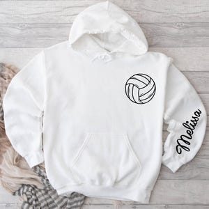 May include: White hooded sweatshirt with a black volleyball graphic and the name "Melissa" on the sleeve.