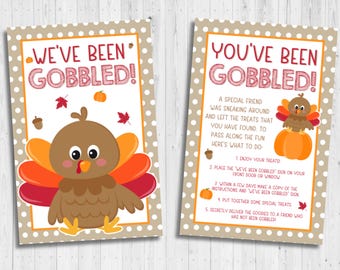 May include: A printable "We've Been Gobbled!" sign with a cute cartoon turkey and instructions for a Thanksgiving game. The sign says "Enjoy your treats!" and "Place the "We've Been Gobbled!" sign on your front door or window."