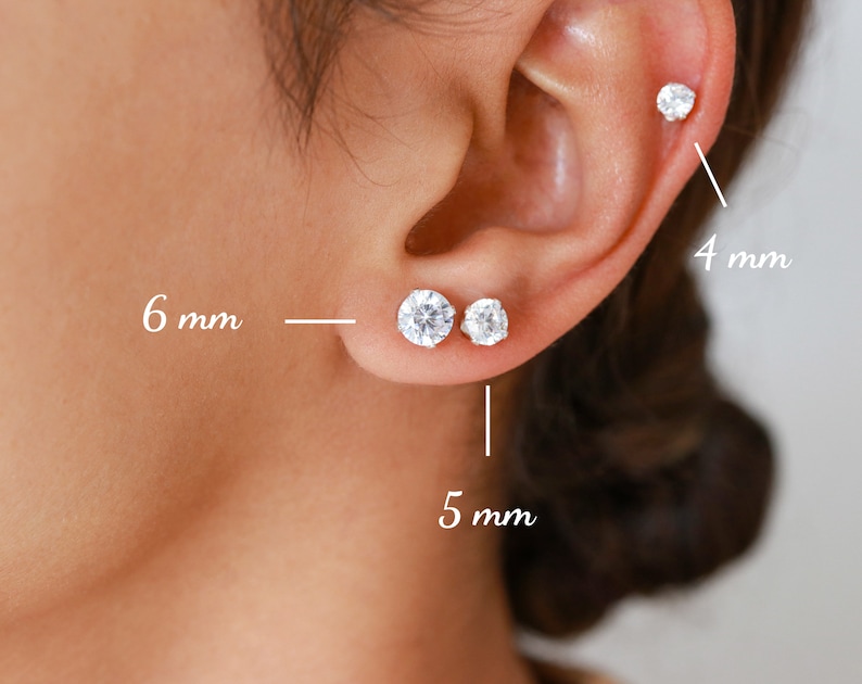 Pu&ograve; includere: Tre paia di orecchini a perno d'argento con pietre di zircone cubico trasparenti. Gli orecchini hanno un diametro di 4 mm, 5 mm e 6 mm.