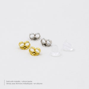 May include: Four earring backs, two gold, two silver, and two clear silicone backs.