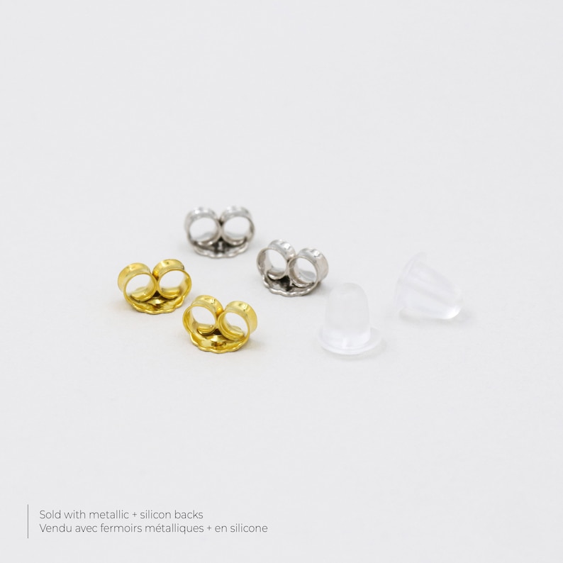 May include: Four earring backs, two gold, two silver, and two clear silicone backs.