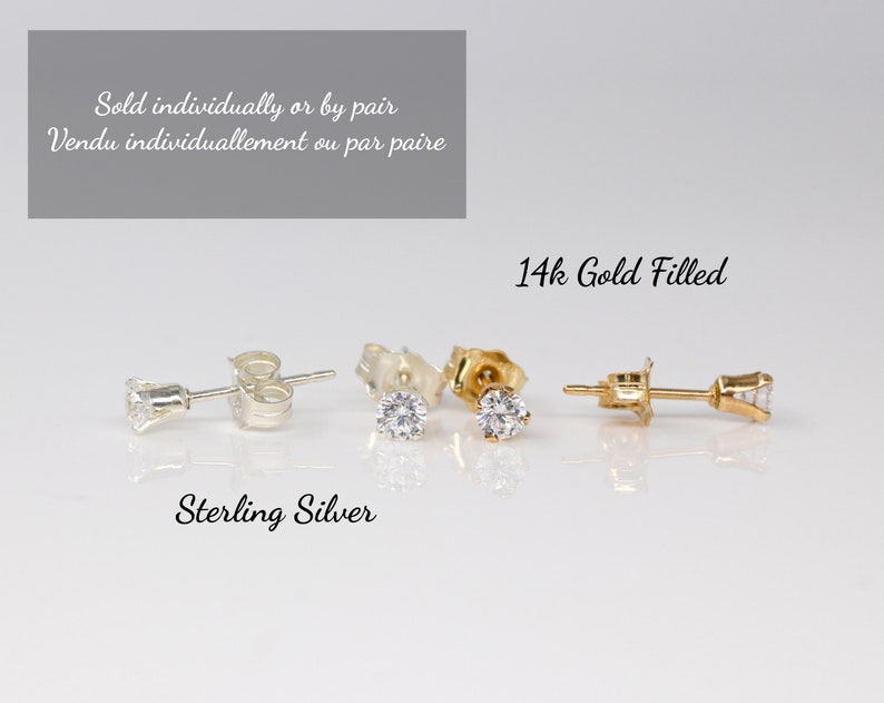 Pu&ograve; includere: Primo piano di tre paia di orecchini a perno con una pietra trasparente. Gli orecchini sono mostrati in tre diverse finiture metalliche: argento sterling, placcato oro 14k e oro. Il testo "Sold individually or by pair" e "Vendu individuallement ou par paire" &egrave; mostrato sopra gli orecchini. Il testo "14k Gold Filled" &egrave; mostrato sopra gli orecchini d'oro. Il testo "Sterling Silver" &egrave; mostrato sotto gli orecchini d'argento.