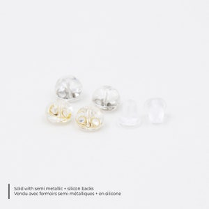 May include: A collection of earring backs, including semi-metallic and clear silicone styles, are displayed against a white background. The image includes text that reads "Sold with semi metallic + silicon backs".
