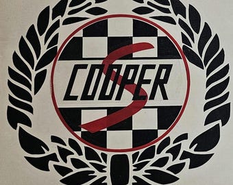 May include: Black and white checkered circle with a red "S" and the word "COOPER" in black lettering. The circle is surrounded by a black laurel wreath.