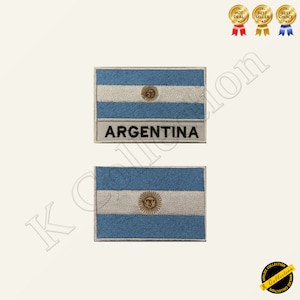 May include: Two embroidered patches featuring the Argentinian flag. The top patch has the flag with the words "ARGENTINA" below. The bottom patch is just the flag.
