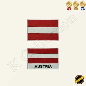 May include: Two embroidered patches featuring the Austrian flag. The top patch shows the red, white, and red stripes of the flag. The bottom patch has the same flag design with the word "AUSTRIA" printed below the flag.