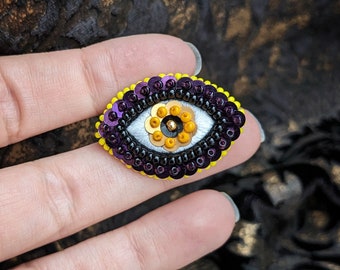 The Fabularium - Hand embroidered purple orange and yellow eye brooch | bead embroidery