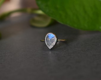 Nathis Moonstone Round Bezel Set Faceted Ring