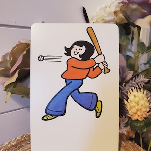 May include: A cartoon illustration of a person swinging a baseball bat. The person is wearing a red shirt, blue pants, and yellow shoes. The person has black hair and is smiling. A white baseball is flying through the air.