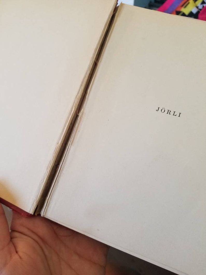May include: A close-up of the spine of a book with the title "J&ouml;rli" printed in black on a white background.