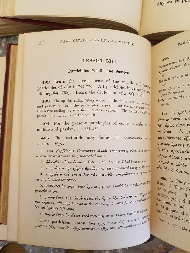 May include: A page from a textbook about the middle and passive voice in Greek. The text includes examples of how to use the middle and passive voice in sentences. The text is in black ink on a white page.