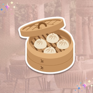 May include: A sticker featuring a cartoon illustration of a bamboo steamer with four dumplings inside. The steamer is light brown with a lid, and the dumplings are white with brown details. The background is a soft pink.