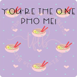 May include: Purple background with a white heart and white polka dots. The text "You're the one who pho me!" is written in black. There are five pink bowls with red chopsticks and noodles inside. Each bowl has a lime wedge and a green leaf.