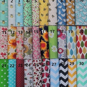 May include: Thirty fabric swatches with various patterns, including bees, sunflowers, strawberries, polka dots, and geometric designs. The swatches are numbered 1 through 30.