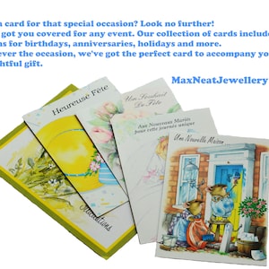 May include: A collection of greeting cards with various designs, including floral and illustrated scenes. The cards feature text in French, with the brand name "MaxNeatJewellery" visible. The cards are suitable for various occasions.