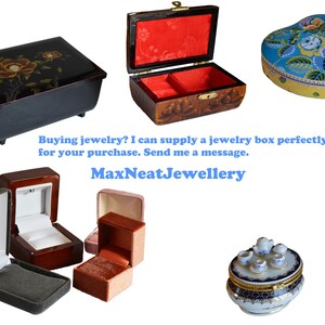 May include: Assortment of jewelry boxes in various shapes and styles. Includes a black rectangular box with floral design, a heart-shaped box with floral pattern, and several ring boxes. Text: MaxNeatJewellery.