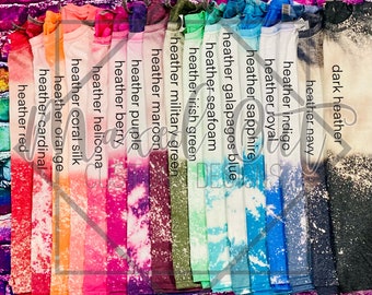 May include: A collection of short-sleeve t-shirts arranged in a row, each featuring a bleached, distressed effect. The colors include heather red, cardinal, orange, coral silk, helicona, berry, purple, maroon, military green, irish green, seafoam, galapagos blue, sapphire, royal, indigo, navy, and dark heather, with corresponding text labels for each.