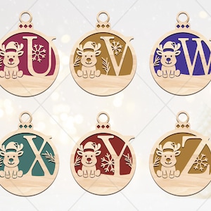 May include: Wooden Christmas ornaments featuring the letters U, V, W, X, Y, and Z. Each ornament has a reindeer design and is painted in various colors, including burgundy, brown, blue, teal, and red. The ornaments are round with a loop for hanging.