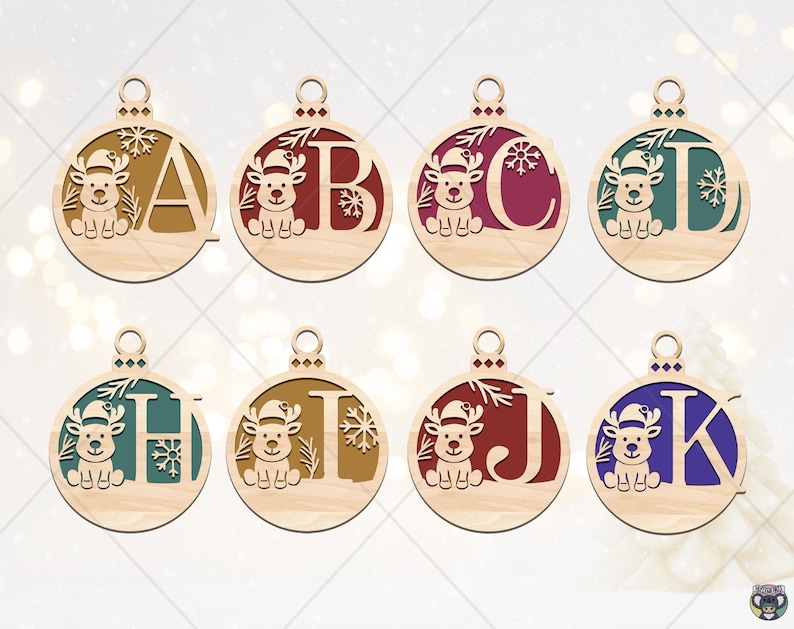 May include: Wooden Christmas ornaments with letters A, B, C, D, H, I, J, and K. Each ornament features a reindeer wearing a Santa hat and snowflakes. The letters are in various colors, including red, green, and blue.