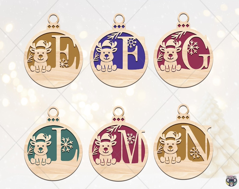May include: Wooden Christmas ornaments with a reindeer design and letters E, F, G, L, M, and N. Each ornament features a different color for the letter and snowflake accents. The ornaments are round with a small hole at the top for hanging.