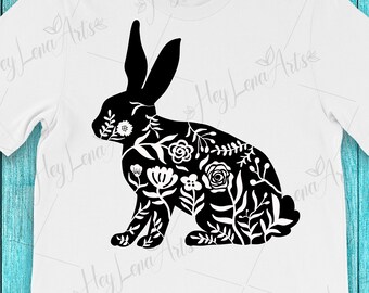 May include: Black silhouette of a rabbit with a floral pattern inside. The rabbit is sitting on its hind legs with its ears up.