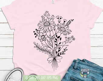 May include: A pink t-shirt with a black and white floral design. The design features a bouquet of flowers with a bow at the bottom.