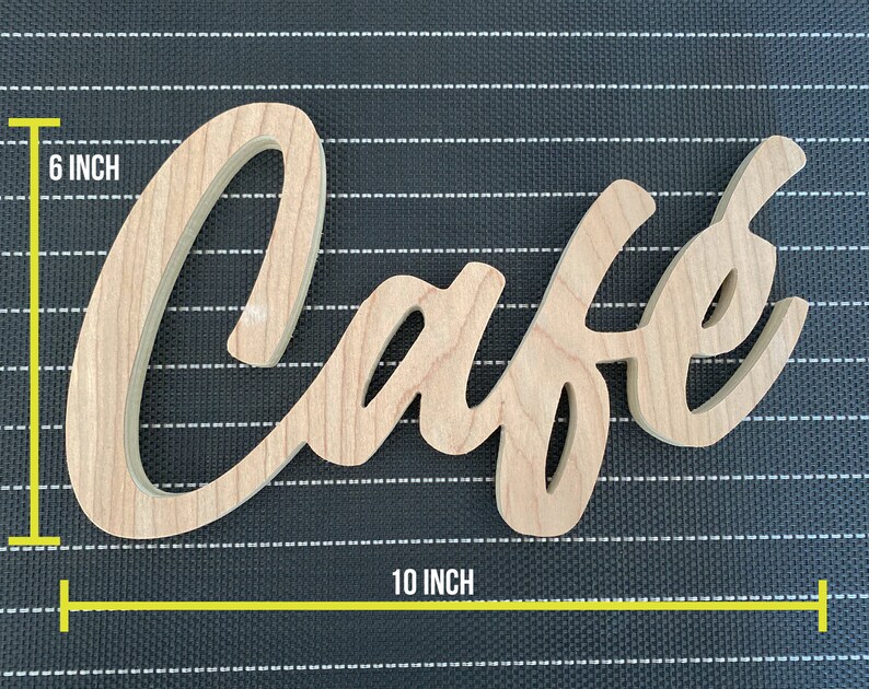 May include: Wooden sign with the word "Cafe" in a cursive font. The sign is 10 inches wide and 6 inches tall.