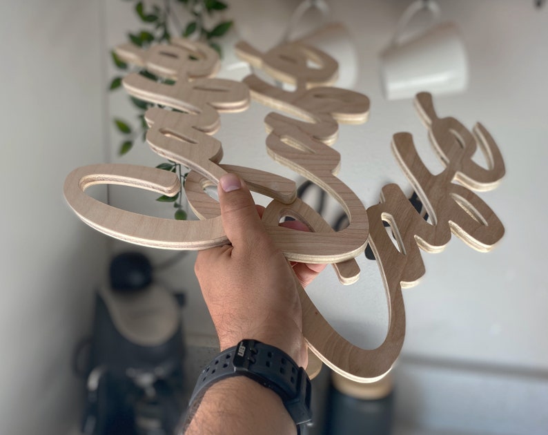 May include: Wooden sign with the words "Love the Coffee" in a cursive font.