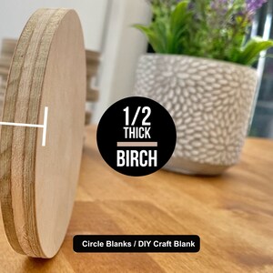 May include: A close-up of a 1/2 inch thick birch wood circle blank. The blank is light brown and has a smooth surface. The text "1/2 THICK BIRCH" is printed on a black circle in the center of the image. The text "Circle Blanks / DIY Craft Blank" is printed below the circle.