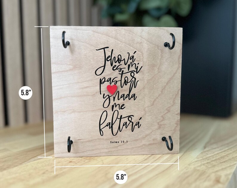 May include: A wooden sign with a red heart and the text "Jehov&aacute; es mi pastor y nada me faltar&aacute;" in black lettering. The sign is 5.8 inches wide and 5.8 inches tall. The text is from Psalm 23:1.