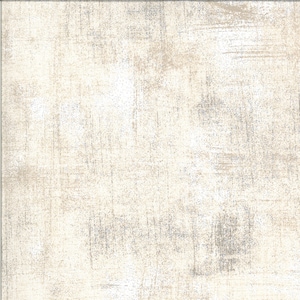 May include: A textured fabric with a subtle, light brown and white pattern. The fabric has a slightly distressed look, giving it a vintage feel.