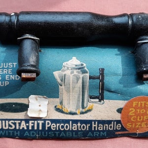 May include: A black wooden handle with adjustable arms for a percolator. The package says "Adjusta-Fit Percolator Handle with Adjustable Arm" and "Fits 2 to 8 Cup Sizes".