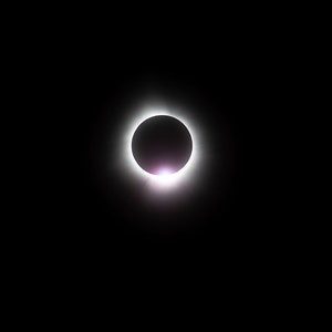 May include: A total solar eclipse, with the moon completely blocking the sun, creating a bright ring of light around the moon's silhouette.